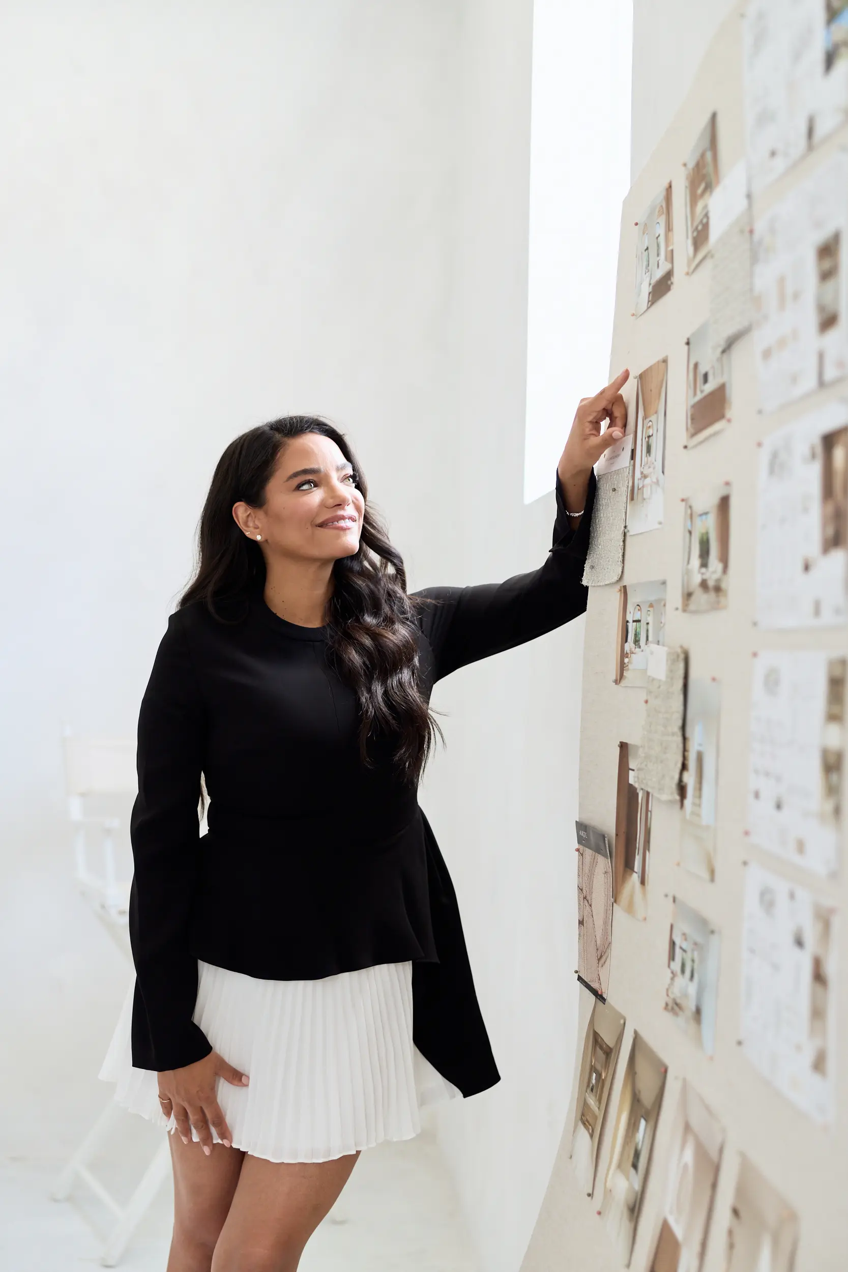 Melissa reviewing a wall of design references